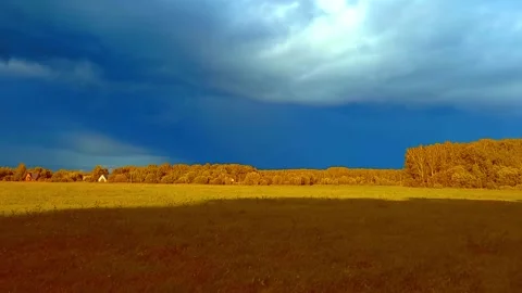 Stormy sky over field in fall. Blurry windy landscape Stock Footage 285044112