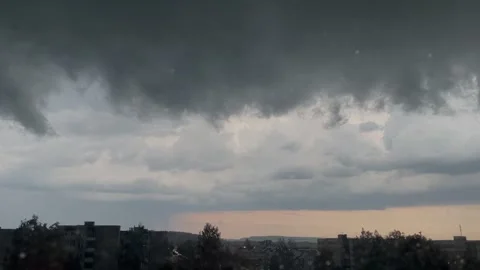 Stormy sky before rain, view from window to city, black clouds Stock Footage 312633364