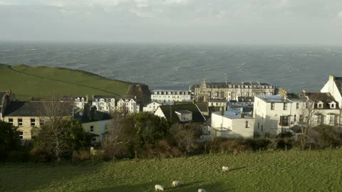 Stormy spring evening in Devon over sheep grazing in village green Stock Footage 136877240