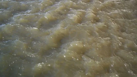 Stormy spring the flow of dirty water. Little waves. Close up. 4K, 25 fps. 스톡 동영상 87738740
