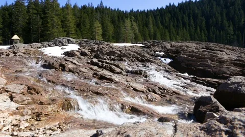 Stormy spring stream flows through stones in  background of  forest 스톡 동영상 74075449