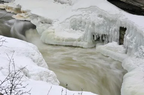 Stormy stream breaking through a layer of ice Stock Photos