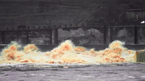 A stormy stream of golden waves from a hydro station Video stock 168928845