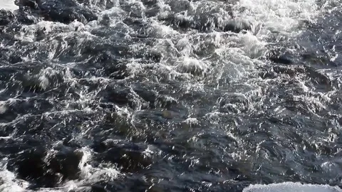 Stormy stream of water in the river in the spring in back lit Stock Footage 84785200