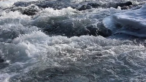 Stormy stream of water in the river in the spring in back lit Stock Footage 84785247