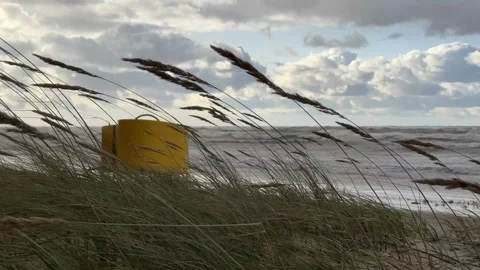 Stormy strong wind at the beach with yellow beach hut Stock Footage 277622209