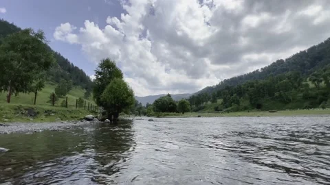 A stormy water flow of a mountain river with a rocky shore. Stock Footage 225111453