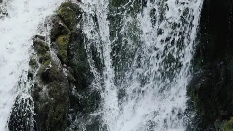 Stormy waterfall rushing between the rocks close up. Water pouring down the Stock Footage 285834369