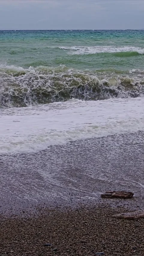Stormy waves breaking on the beach vertical video Stock Footage 313526597