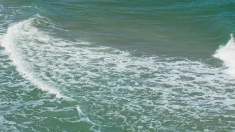 Stormy waves come ashore, shot on a telephoto lens. Long shot taken with a Stock Footage 217727259