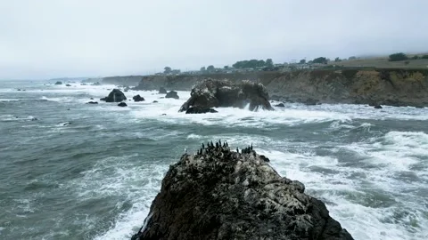 Stormy waves crash along Arched Rock in Sonoma County Bodega Bay along Stock Footage 219945273