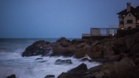 Stormy Waves Crashing On Rocks Below New England Beach House, 4k Long Exposure Video stock 89851400