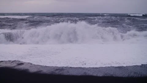 Stormy waves hitting black sand beach in Iceland in slow motion Stock Footage 306524979