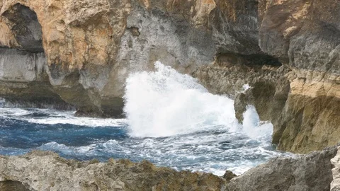Stormy waves hitting cliffs inside a blue sea Stock Footage 108391210