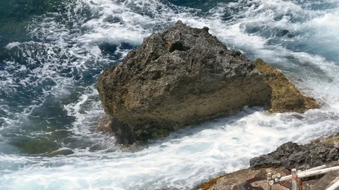 Stormy waves hitting cliffs inside a blue sea Stock Footage 112346436