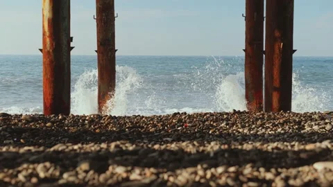 Stormy waves, old bridge columns, sunlight patterns, Stock Footage 222042469
