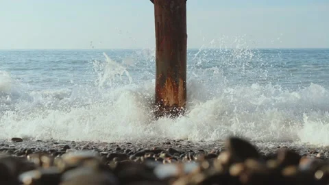 Stormy waves, old bridge columns, sunlight patterns 스톡 동영상 222042531