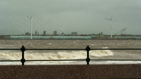 Stormy waves on the river with wind turbines in the background 1 Stock Footage 666583