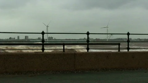 Stormy waves on the river with wind turbines in the background 2 Stock Footage 672571