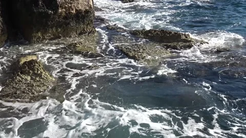 Stormy waves splashing over rugged limestone coastal rocks audio Video stock 342394258