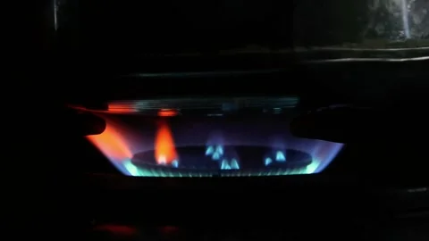 The stove fire burning in the dark kitchen. the fire burning red and blue Stock Footage 309589492
