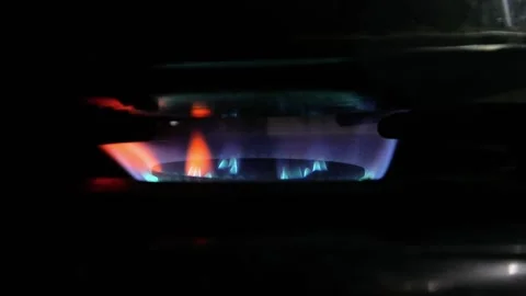 The stove fire burning in the dark kitchen. the fire burning red and blue Stock Footage 309589506