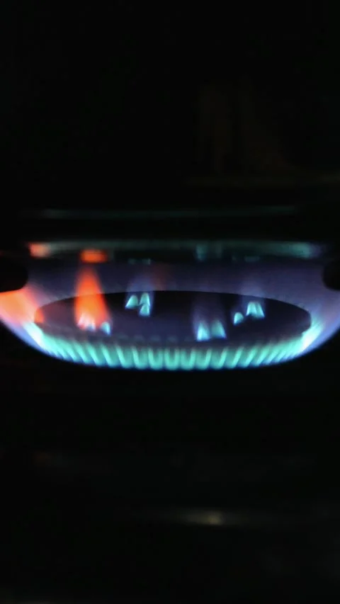 The stove fire burning in the dark kitchen. the fire burning red and blue Stock Footage 309589517