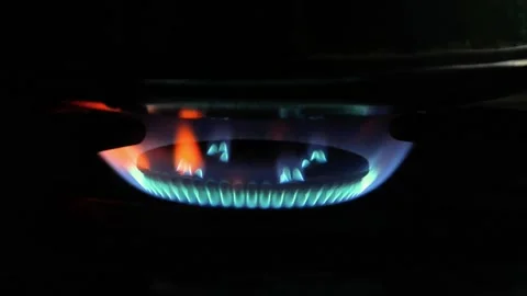 The stove fire burning in the dark kitchen. the fire burning red and blue Stock Footage 309589518