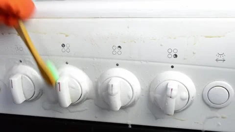 The stove has four knobs and a light Stock Footage 303227080