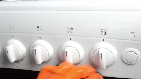 The stove has four knobs and a light Stock Footage 303227089