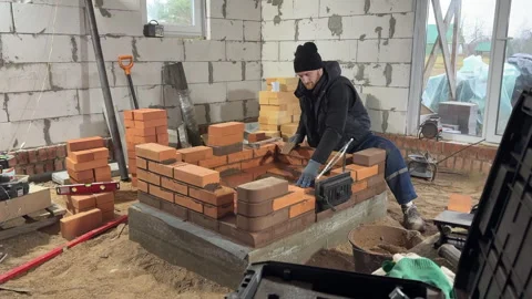 Stove maker builds a heating stove. Wide shot Video stock 322961158