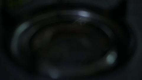 Stove top burner igniting into a blue cooking flame Stock Footage 128216852