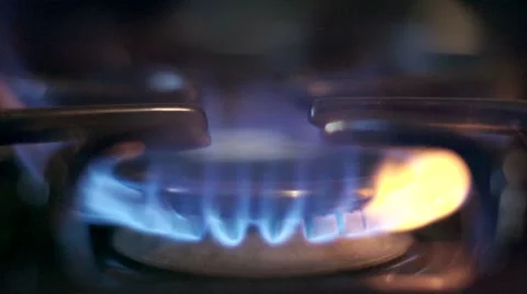 Stove top burner igniting in slow motion Stock Footage