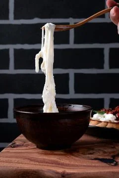 Stracciatella cheese on the fork 스톡 사진