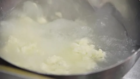 Stracciatella cheese preparation process in stainless steel bowl with water Stock Footage 333864089