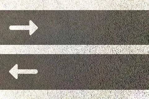 Straight arrows painted on road in both lanes for directional movement of Stock Illustration