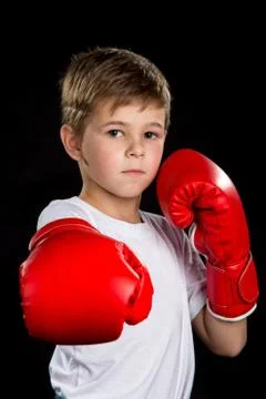 Straight boxing attack kick, demonstration in red boxing gloves. Confident Stock Photos