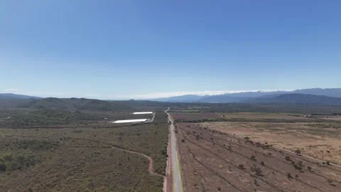 Straight Country Road Cutting Through Arid Countryside and Farmland, Salta, Arge Stock Footage 343672377