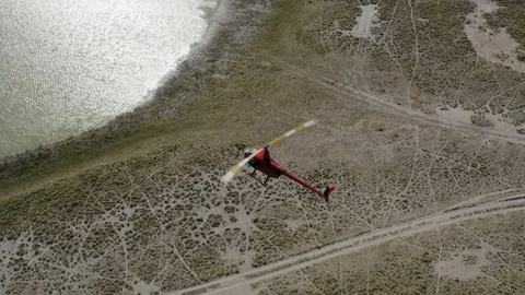 Straight down aerial view of a helicopter taking tourists for a scenic flight Stock Footage 107227137