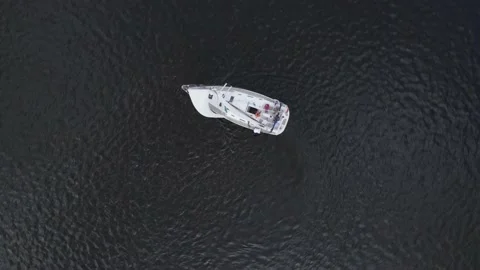 Straight down birds eye view from drone on Sailing yacht on dark blue water. Stock Footage 169864941
