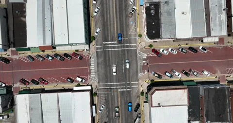 Straight down descending view of traffic passing through a city intersection Video stock 335673241