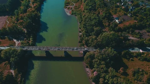 Straight down drone footage of bridge or road in middle green river. 4K. Stock Footage 110283759