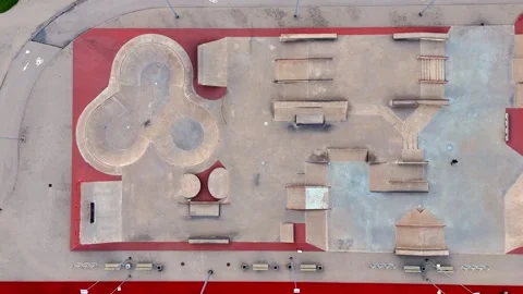 Straight-down drone shot of an empty concrete skatepark with a sculpted bowl Stock Footage 346311056