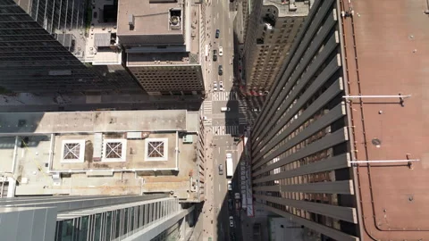Straight down drone view between tall towers and busy roadway Stock-Footage 328215203