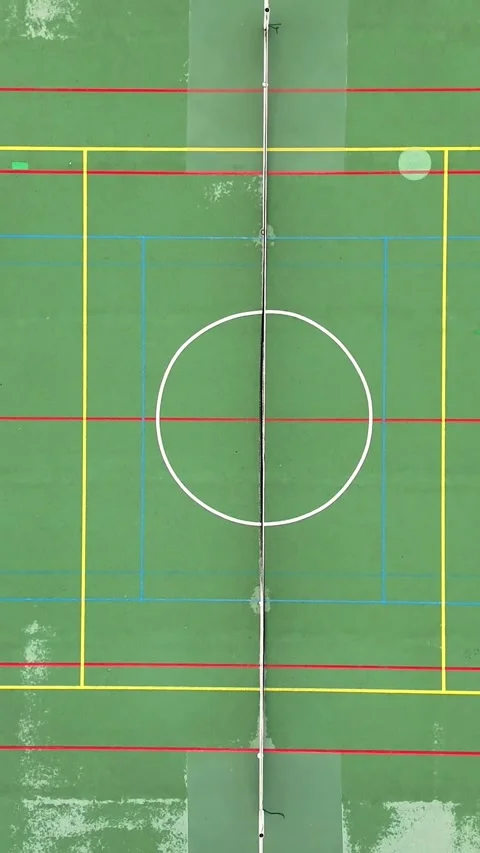 Straight-down drone view of a green multi-sport court with center circle 스톡 동영상 348386937