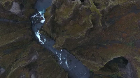 Straight down on rapids between moss padded canyon walls 動画素材 64168008