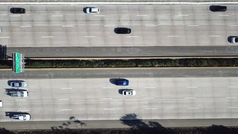 Straight down shot of busy 8 lane California freeway Stock Footage 84775251