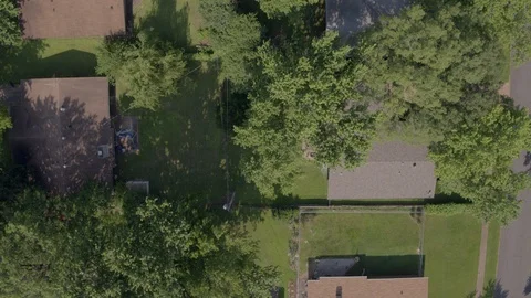 Straight down view and pull back over suburban houses streets and trees Stock Footage 111566433