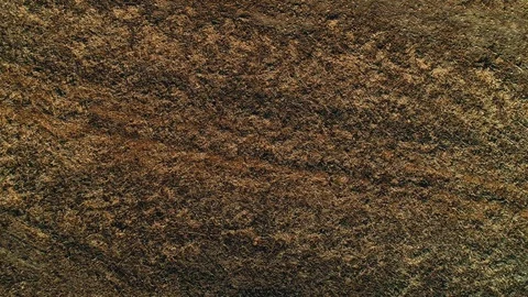 Straight down view on a field ploughed for seeding, drone flying up and brown Stock Footage 124030204