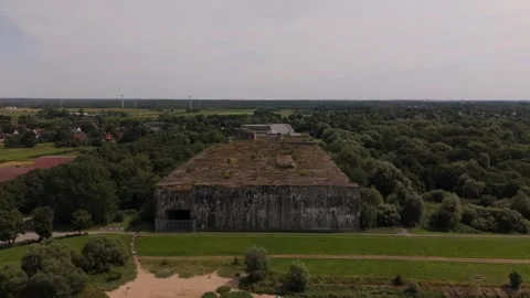 Straight head-on Denkort bunker Valentin Drone 4K with windmill in background Stockbeeldmateriaal 334232500